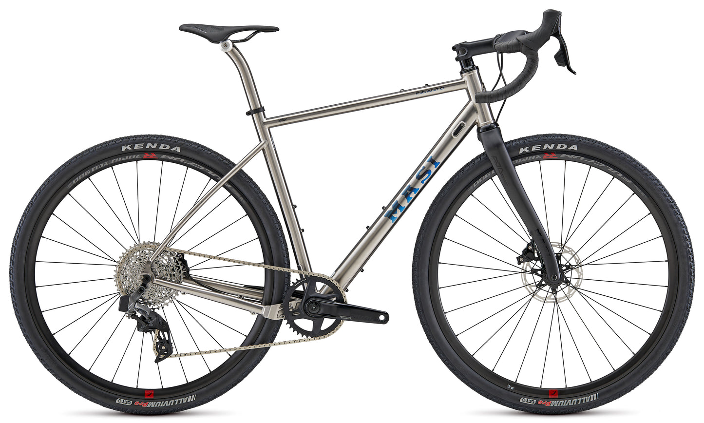The INCANTO RIVAL AXS by Masi Bikes, a silver and black road bike, features Coefficient handlebars, disc brakes for improved aerodynamics, a sleek frame with large Kenda tires, and a detailed gear system. Its modern design stands out against the white background.