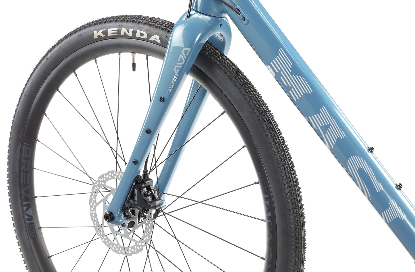 Close-up of a BRUNELLO 1 blue bicycle front wheel with Kenda tires, disc brake, Masi on the frame, and visible spokes.
