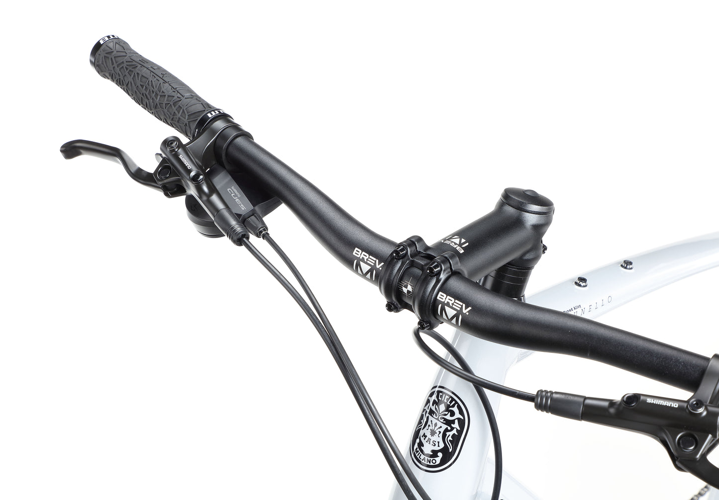 Close-up of BRUNELLO 3s black handlebars with brake levers and textured grips, showing part of its gray frame.