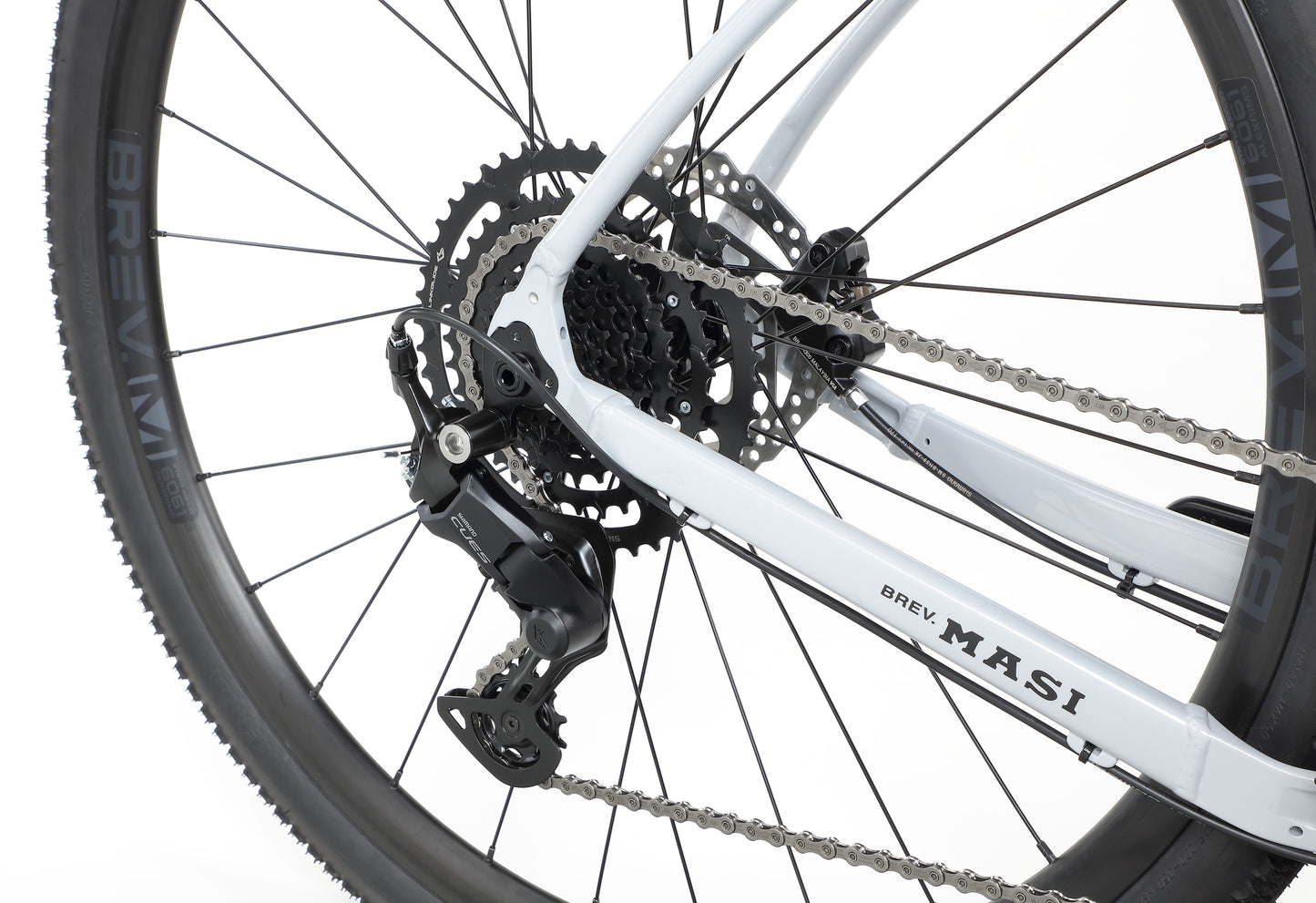 Close-up of the BRUNELLO 3s rear wheel and gear mechanism, showing a chain and disc brake against a white background.