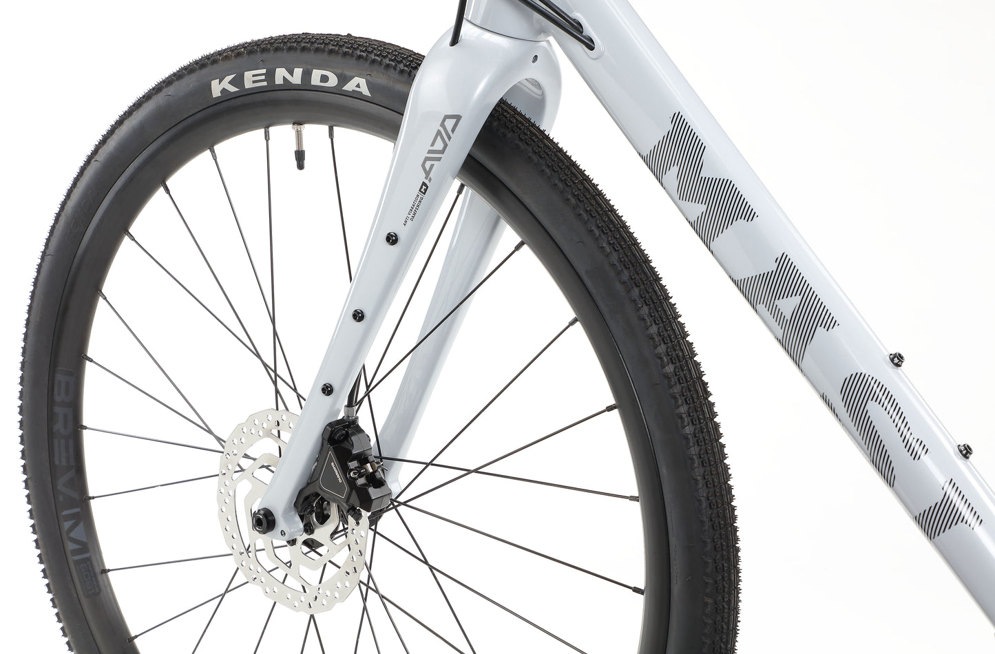 Close-up of a BRUNELLO 3 bicycles front tire and disc brake, with a Kenda tire and MASH on the frame.