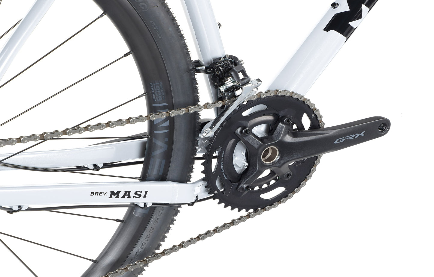 Close-up of the BRUNELLO 1s rear wheel and crankset. The chain encircles the gears on a white frame with MASI branding.