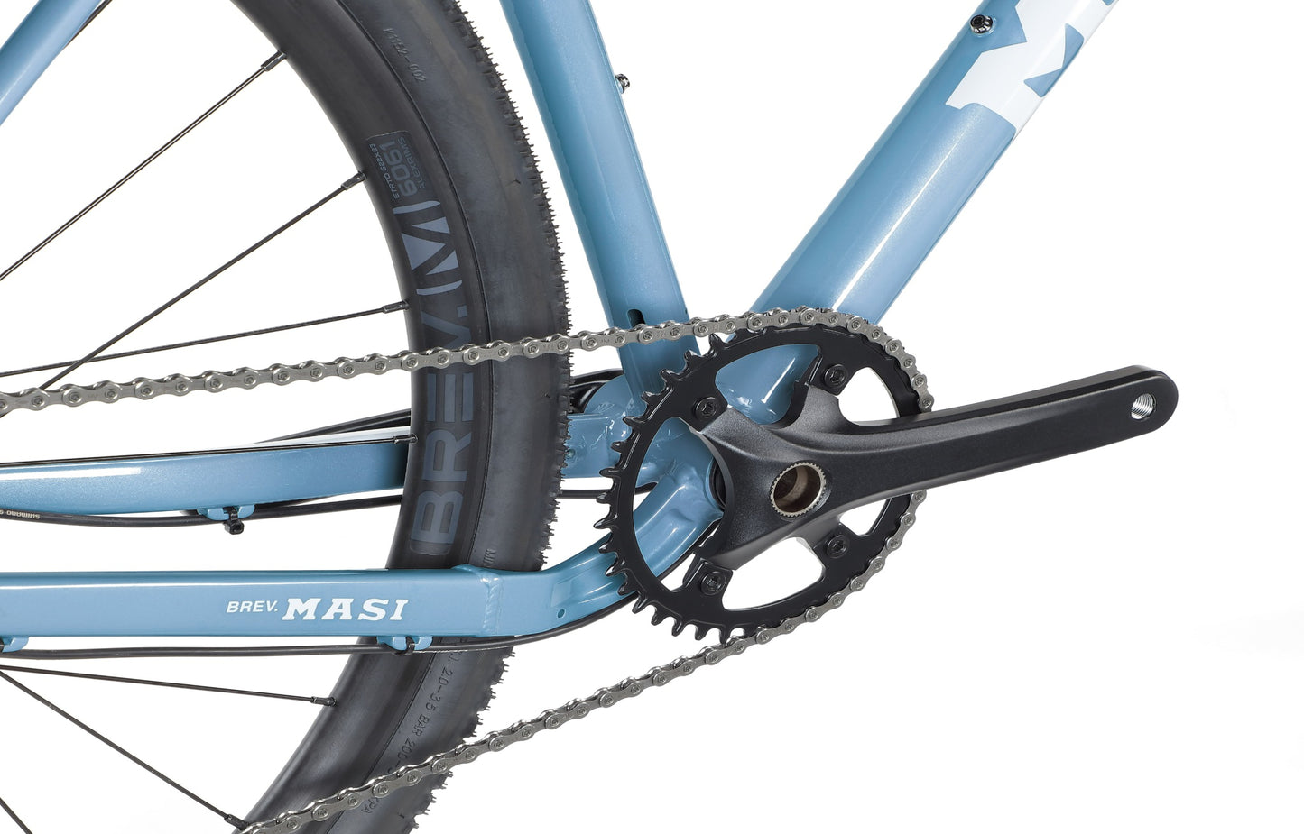 Close-up of a BRUNELLO 3 blue bicycles rear, detailing the crankset, chain, and tire with visible brand markings.