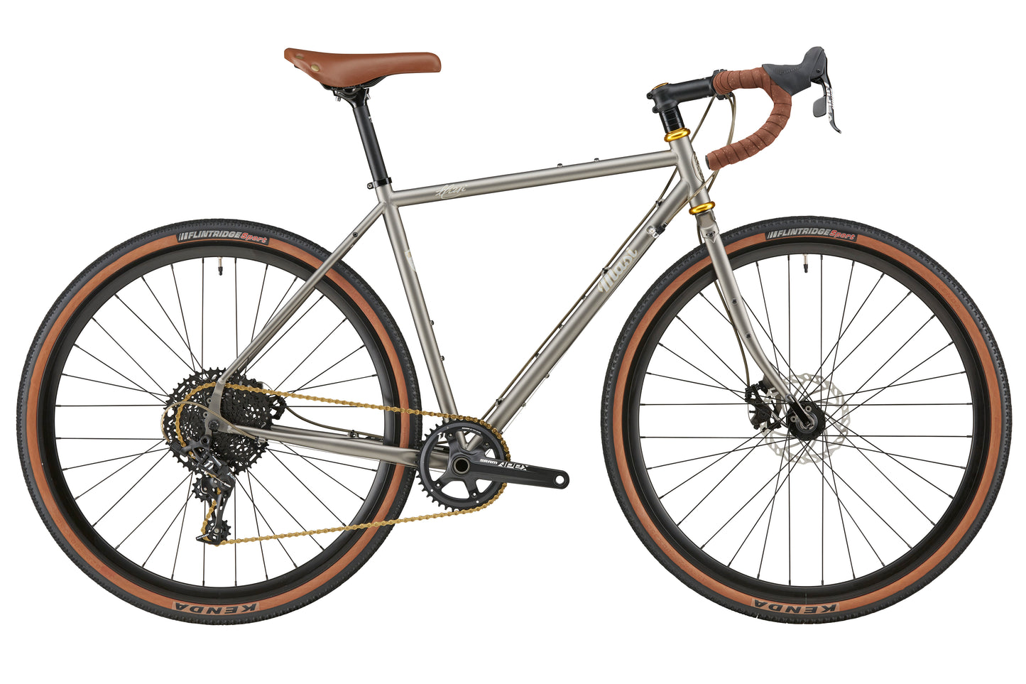 A side view of the CATALINA 1: silver gravel bike with brown handlebars, chromoly steel frame, wide tires, and disc brakes on white.