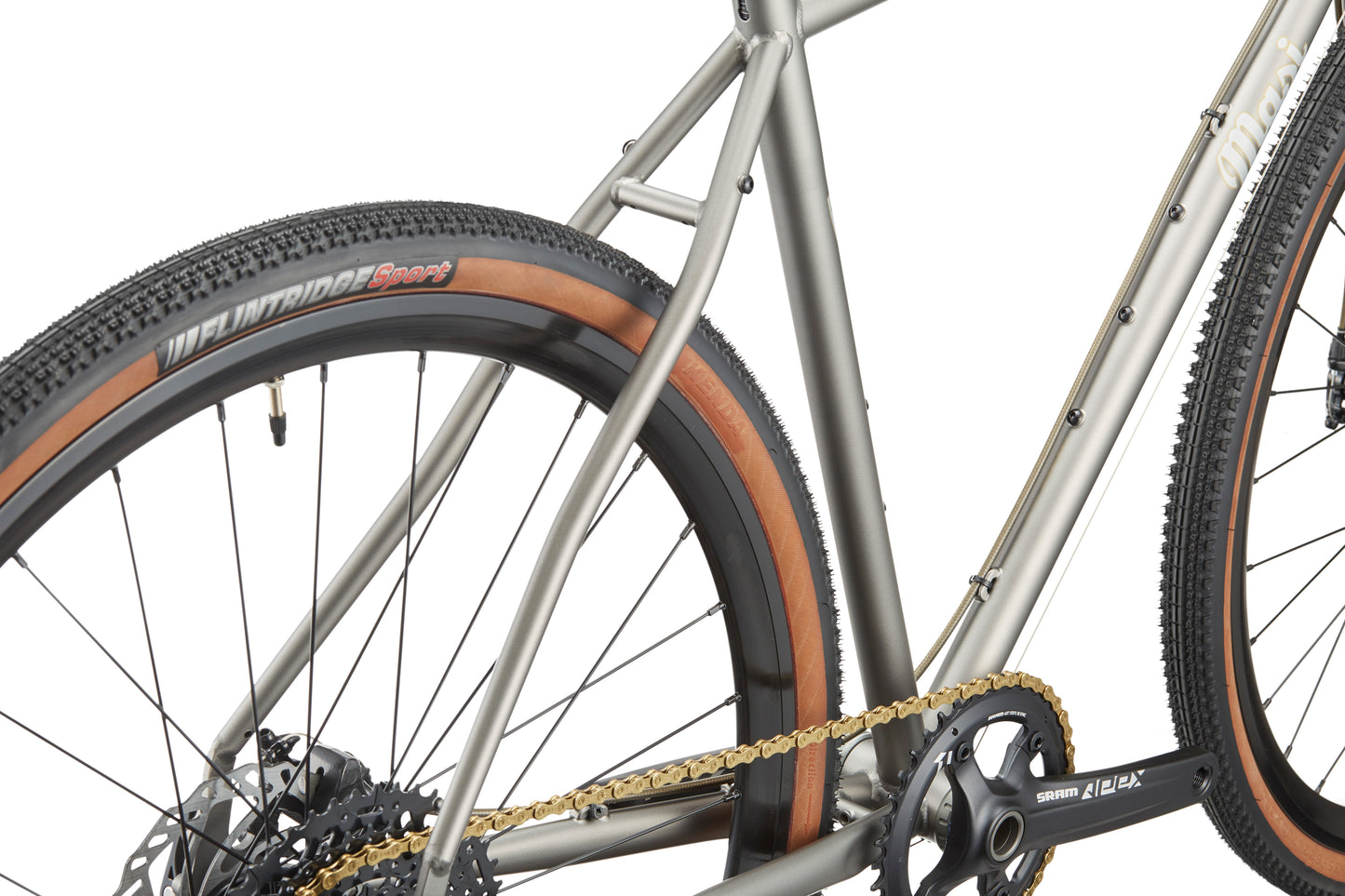 Close-up of the CATALINA 1 chromoly steel frame with rear tan sidewall tire, gears, and chain on a white background.