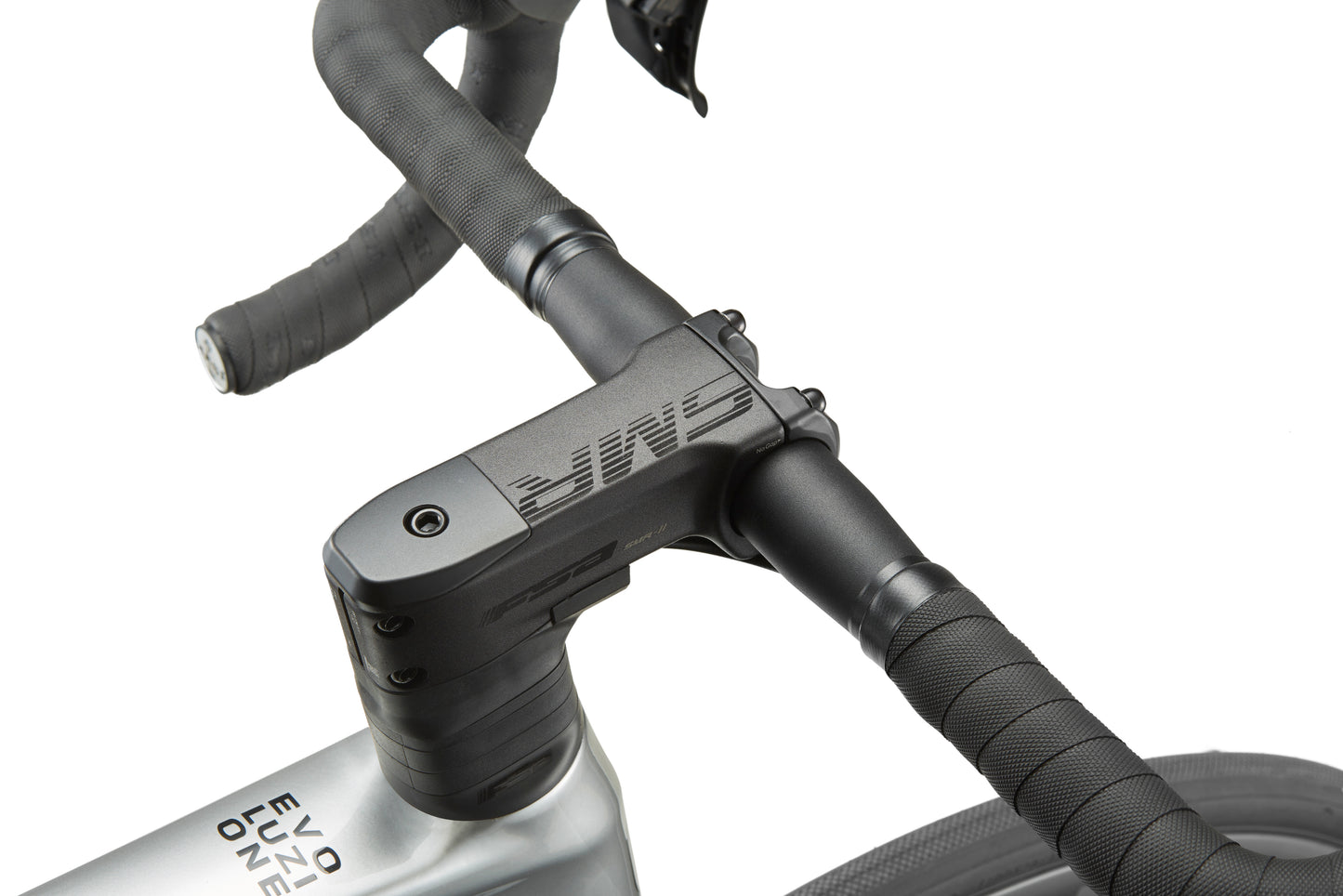 Close-up of a sleek road bike handlebar and stem with black tape and branding, hinting at the Masi EVOLUZIONE 1s metallic silver frame.