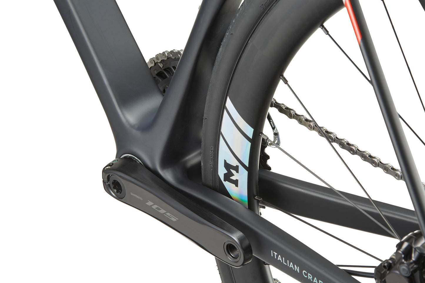 Close-up of the GRAN CORSA carbon road bike frame and rear wheel, highlighting the crank arm, chain, and tire details.