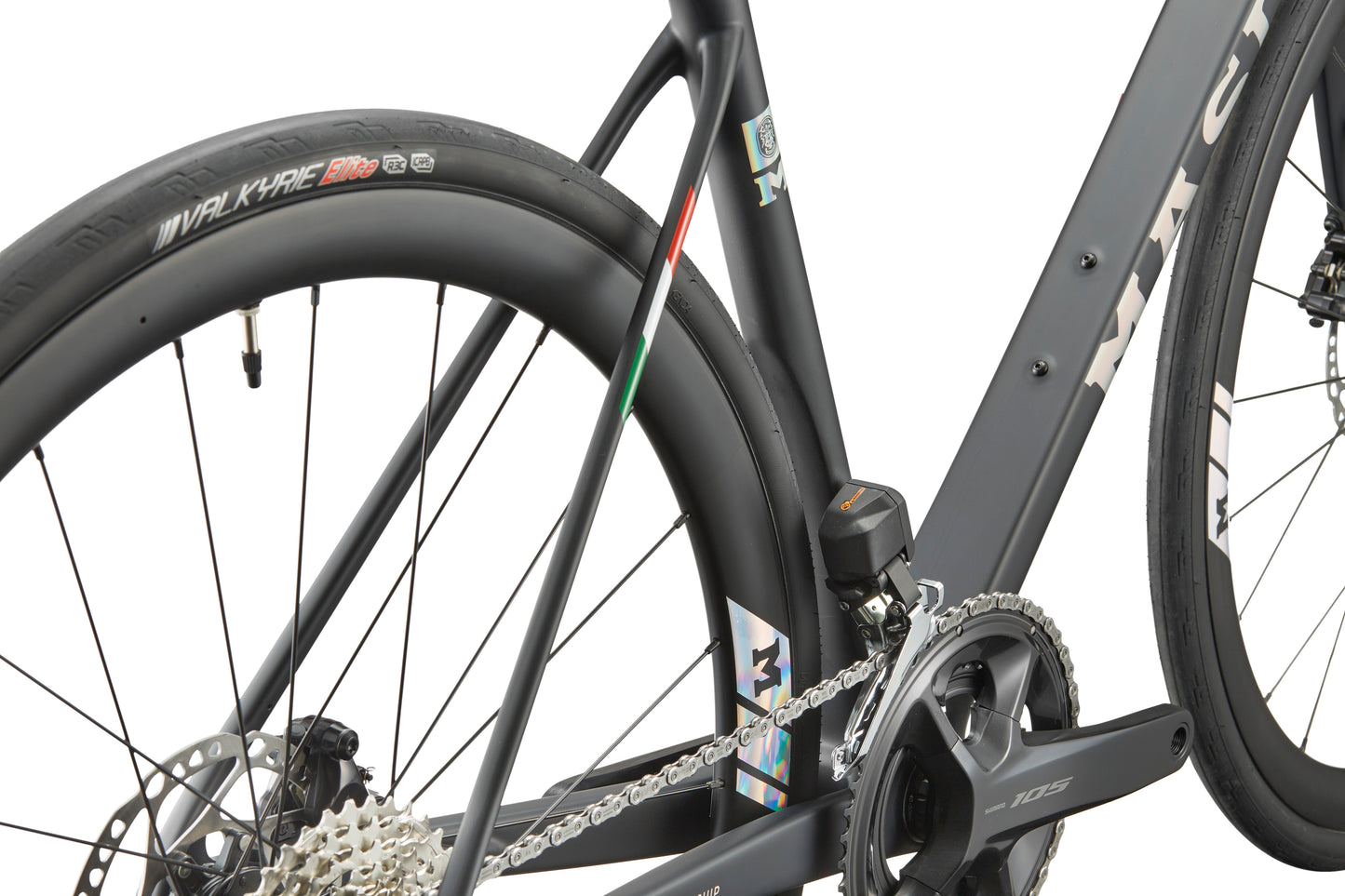 Close-up of GRAN CORSA carbon road bike’s rear wheel, gears, frame branding, and Valkyrie tire label.