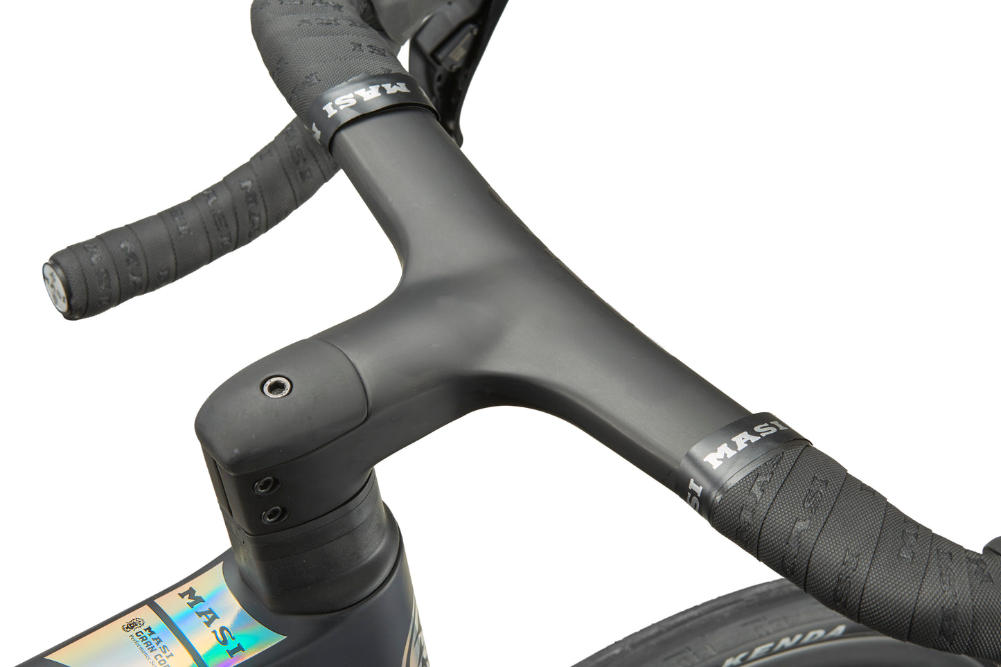Close-up of GRAN CORSA’s integrated handlebar and stem, textured bar tape, and part of the carbon front wheel visible.