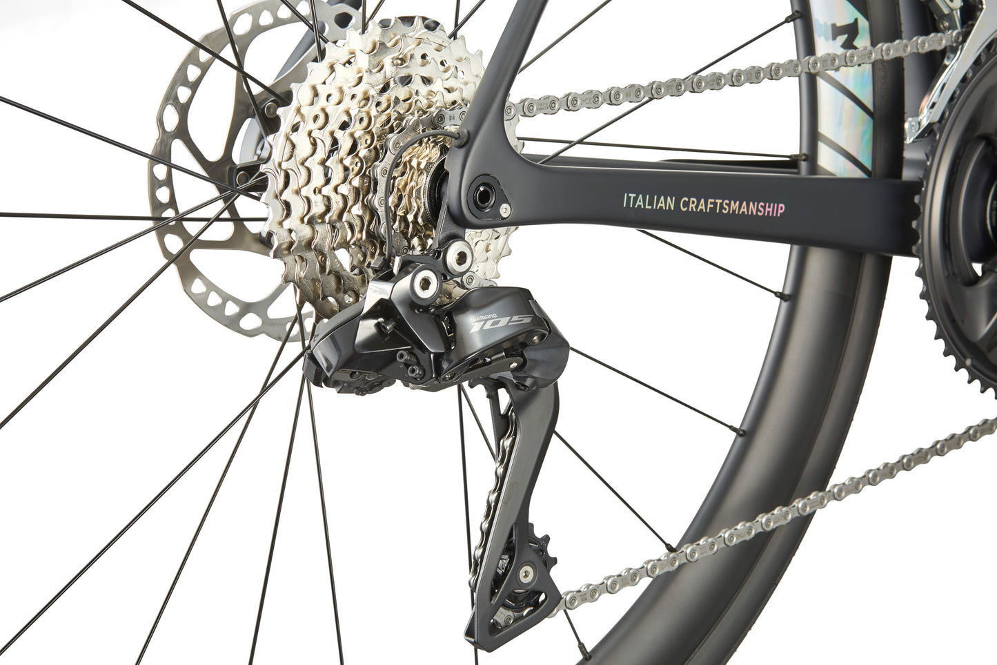 Close-up of the GRAN CORSA carbon road bikes rear derailleur, cassette, and chain with ITALIAN CRAFTSMANSHIP on the frame.