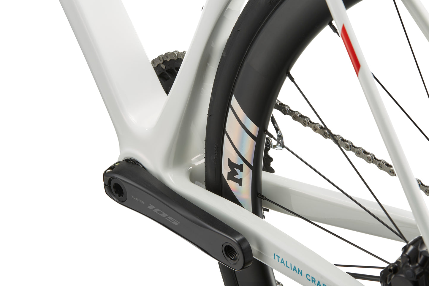 Close-up of a GRAN CORSA carbon road bike frame, rear wheel, crank arm, chain, and a label reading ITALIAN CRAFT.