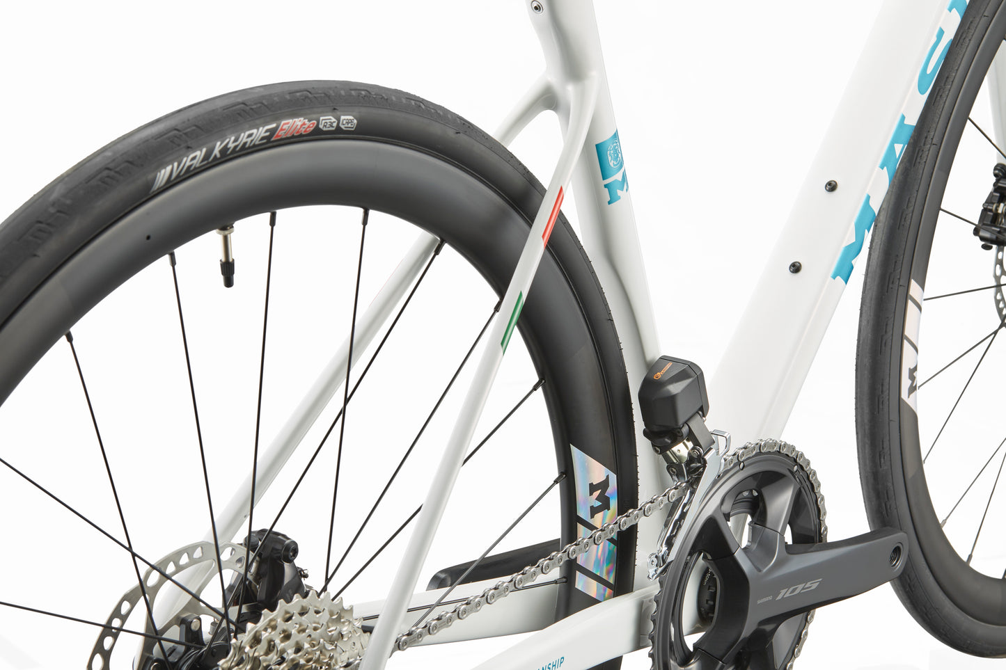Close-up of the GRAN CORSA carbon road bike frame with rear wheel, gear cassette, chain, and crankset on a white background.