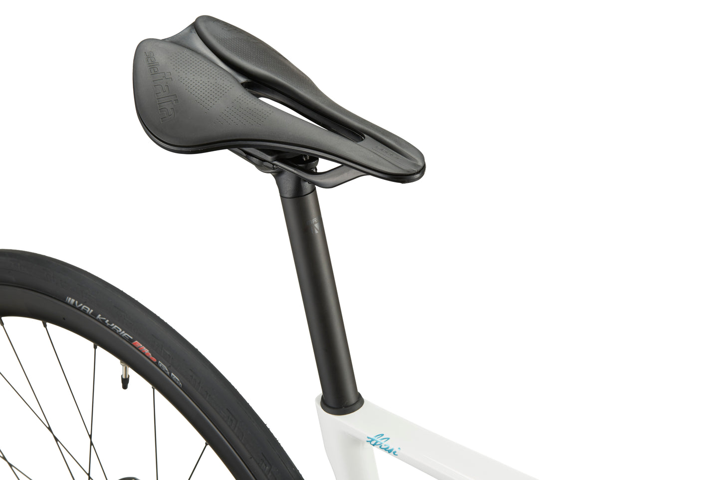 Close-up of black saddle and seatpost on a white GRAN CORSA road bike, with part of the rear wheel visible.