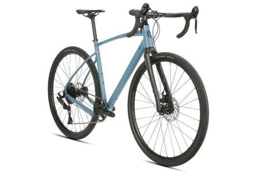 BRUNELLO ADX: Blue road bike with black handlebars, disc brakes, thin tires, aluminum gravel frame, and full carbon fork on white background.