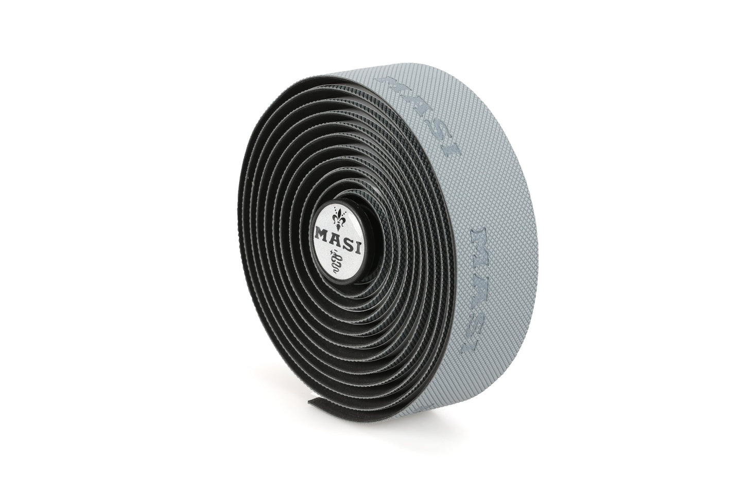 A coiled roll of gray MASI GRIPPER TAPE from Masi Bikes, featuring a textured surface and logo on the end cap, is positioned upright on a white background.