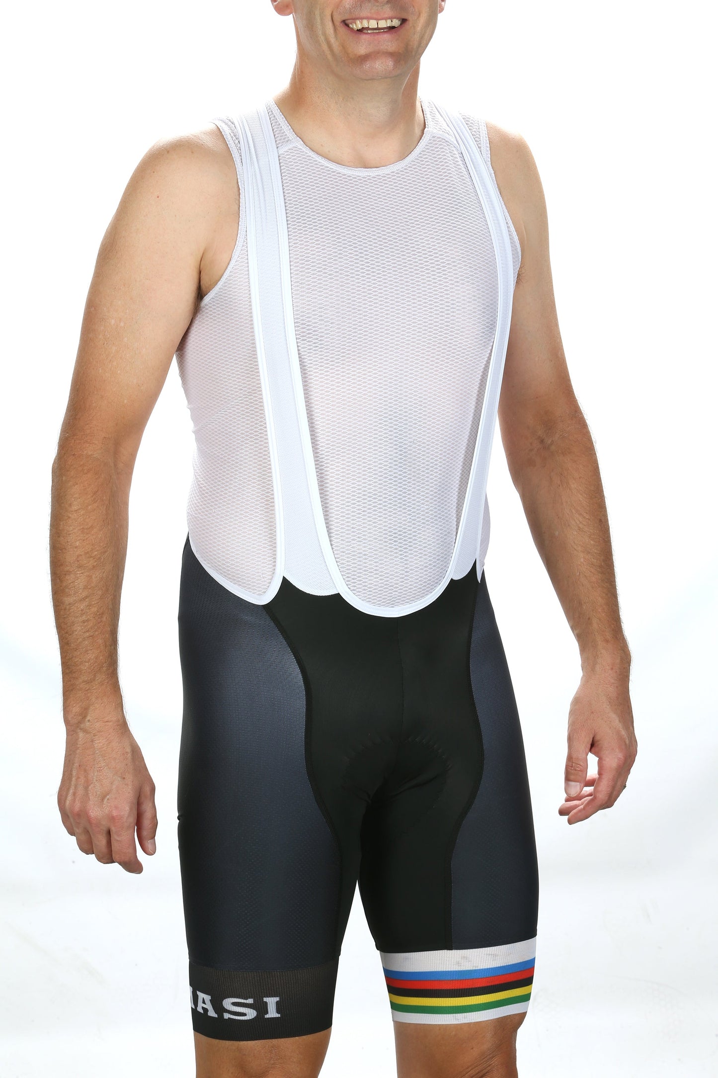 Someone is wearing a sleeveless, white mesh bib with black shorts from Masi Bikess Masio Legac Bibs. The shorts showcase the vibrant Castelli Progretto X2 Air chamois design and have a colorful stripe on one leg against a plain white backdrop.