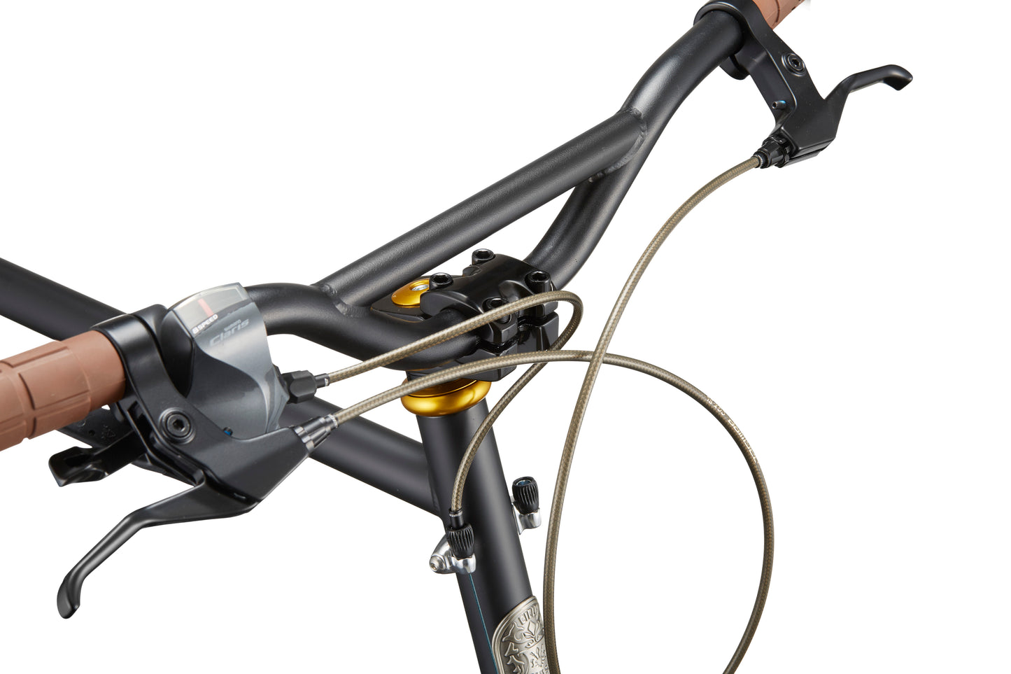 Close-up of STELVIO 3 MiniVelo’s handlebars—brown grips and cables add an urban, sophisticated touch.
