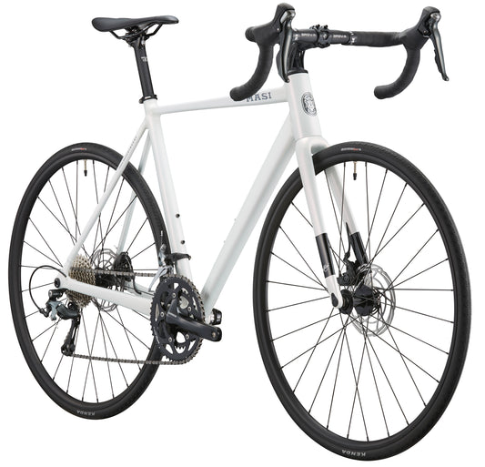 The VINCERE 3, a sleek road bike with an alloy frame, drop handlebars, and Shimano Tiagra disc brakes, seen from a slight angle.