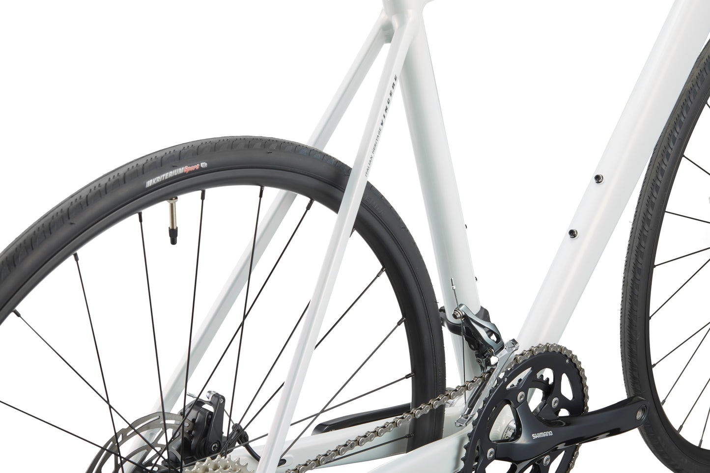 Close-up of a VINCERE 3 bike, highlighting its sleek white alloy frame, rear wheel, and Shimano Tiagra gear mechanism.