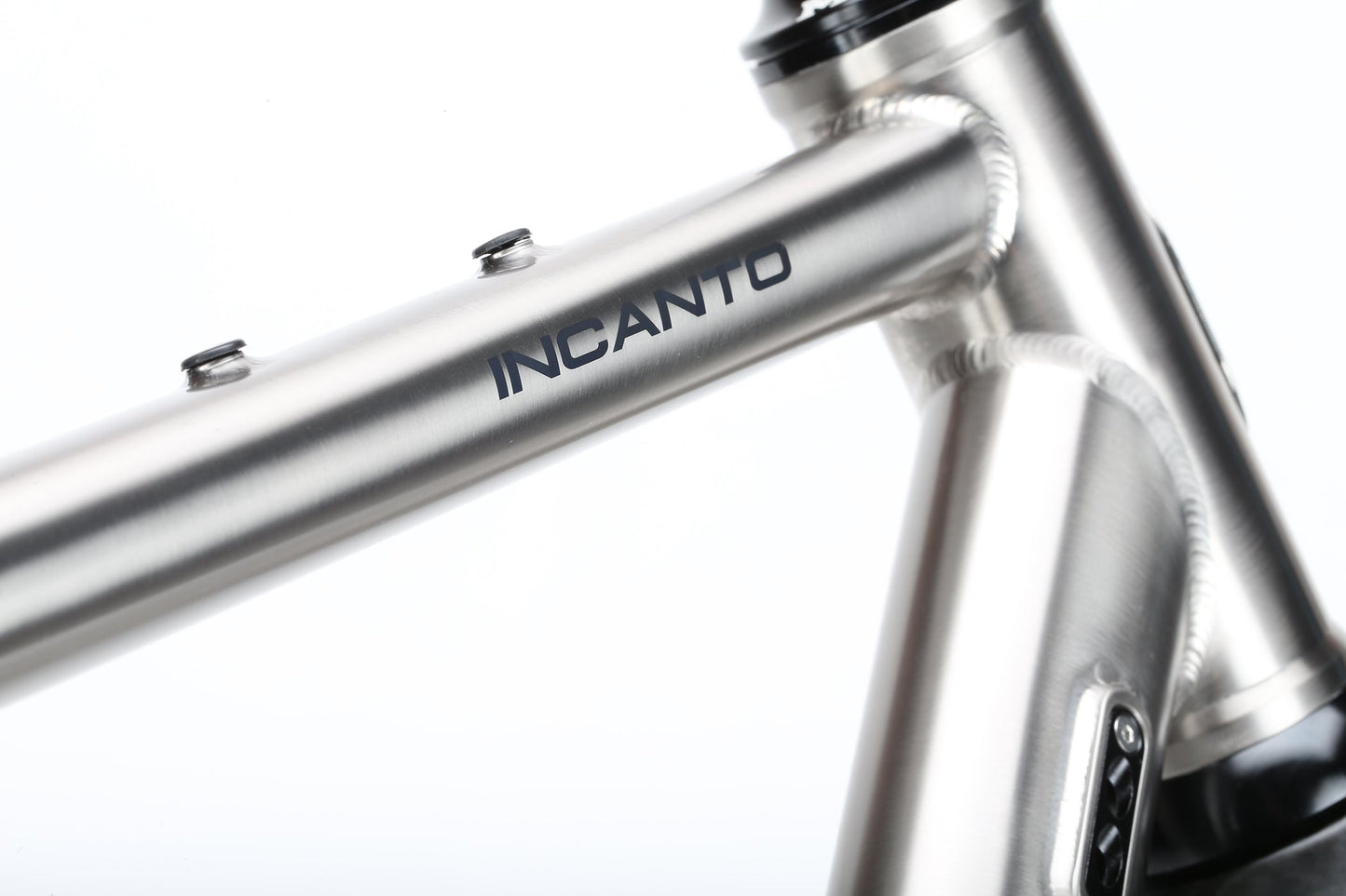 A close-up of the INCANTO Ti FRAMESET by Masi Bikes showcases INCANTO on the top tube. The 3AL/2.5V titanium tubing and clean welds create a sleek, modern look against a plain white background, reflecting an ideal blend for gravel bike adventures.