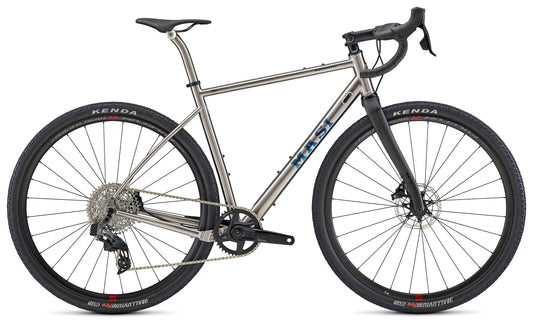 The INCANTO RIVAL AXS by Masi Bikes, a silver and black road bike, features Coefficient handlebars, disc brakes for improved aerodynamics, a sleek frame with large Kenda tires, and a detailed gear system. Its modern design stands out against the white background.