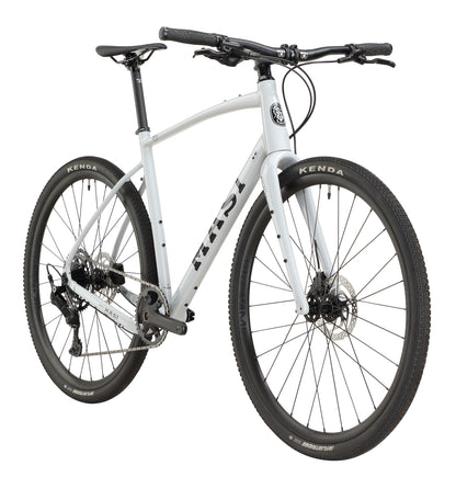 The BRUNELLO 3 is a sleek, modern white bike with black Kenda tires and disc brakes, viewed from a front-side angle on a white background.