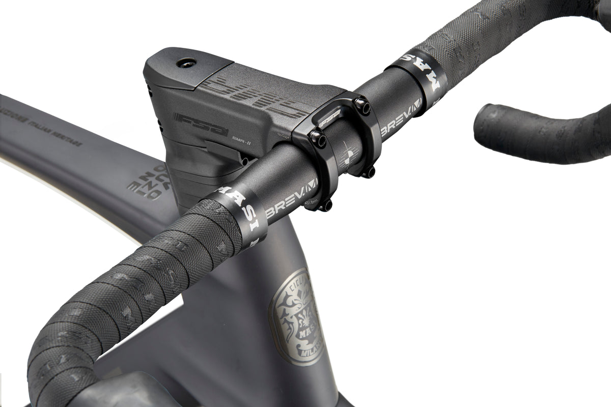 Close-up of a black EVOLUZIONE 1 handlebar with textured grips and BREAKR stem, highlighting its high-performance aerodynamic design.