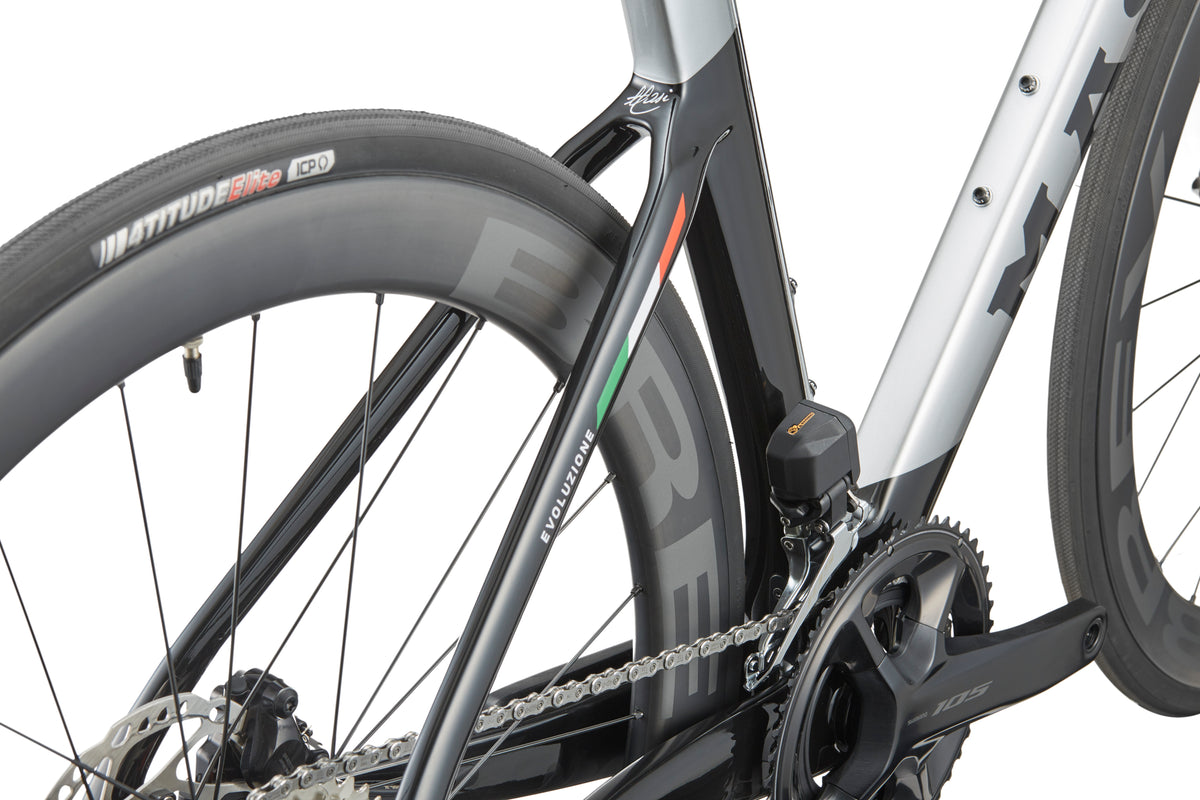 Close-up of the rear wheel and chain of a Masi EVOLUZIONE 1 showing its aerodynamic design with colorful stripes and branded components.