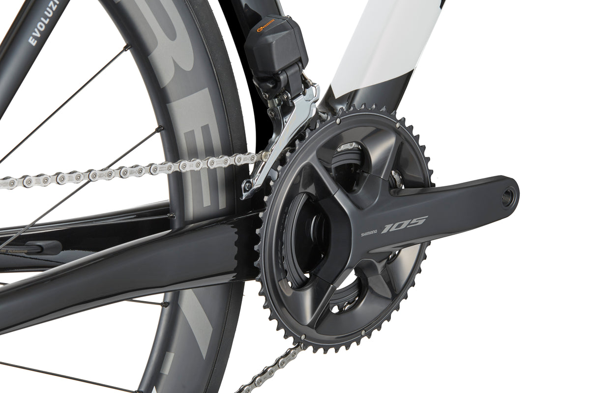 Close-up of an EVOLUZIONE 1 drivetrain featuring a high-performance Shimano 105 crankset, chain, and aerodynamic rear wheel with visible spokes and tire.