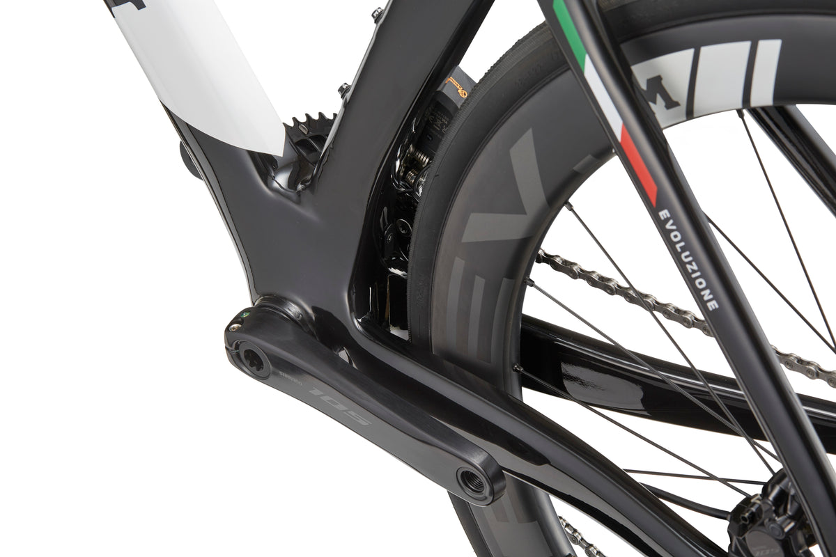 Close-up of EVOLUZIONE 1, showcasing its aerodynamic road bike frame with focus on crankset and rear wheel.