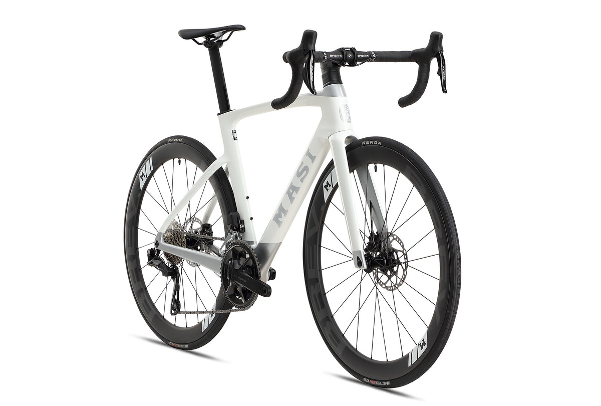 The EVOLUZIONE 1 by Masi Bikes is a sleek carbon road bike with an aerodynamic design, drop handlebars, disc brakes, and large black wheels with sporty rims. The Masi logo is prominently displayed on the frame against a pristine white background.