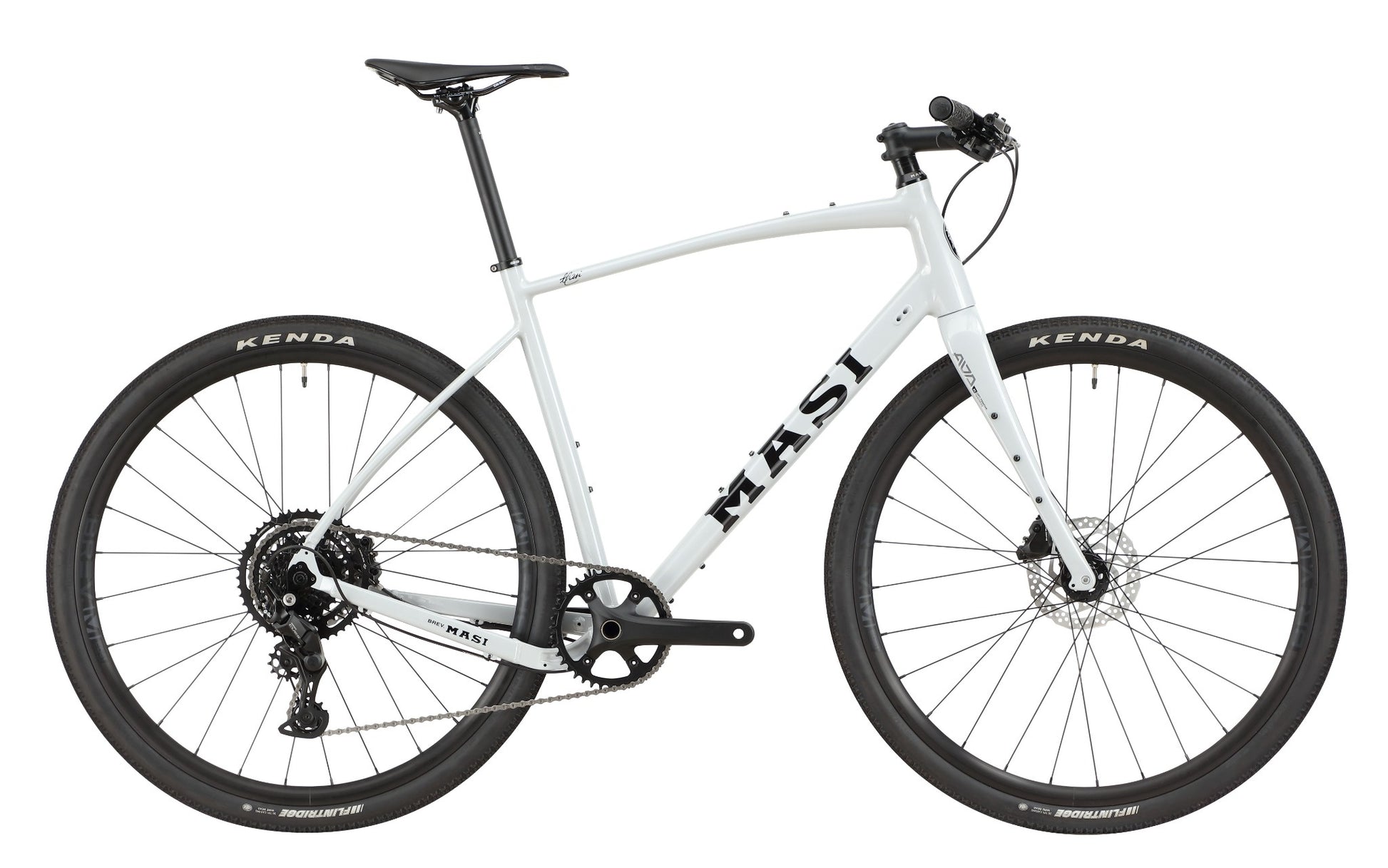 The BRUNELLO 3 is a light gray Masi gravel bike with an alloy frame, tubeless-ready wheels, disc brakes, and a flat handlebar.