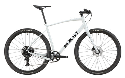 The BRUNELLO 3 is a light gray Masi gravel bike with an alloy frame, tubeless-ready wheels, disc brakes, and a flat handlebar.