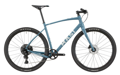 The BRUNELLO 3 is a blue Masi gravel bike with a light alloy frame, disc brakes, tubeless-ready wheels, and a flat handlebar.