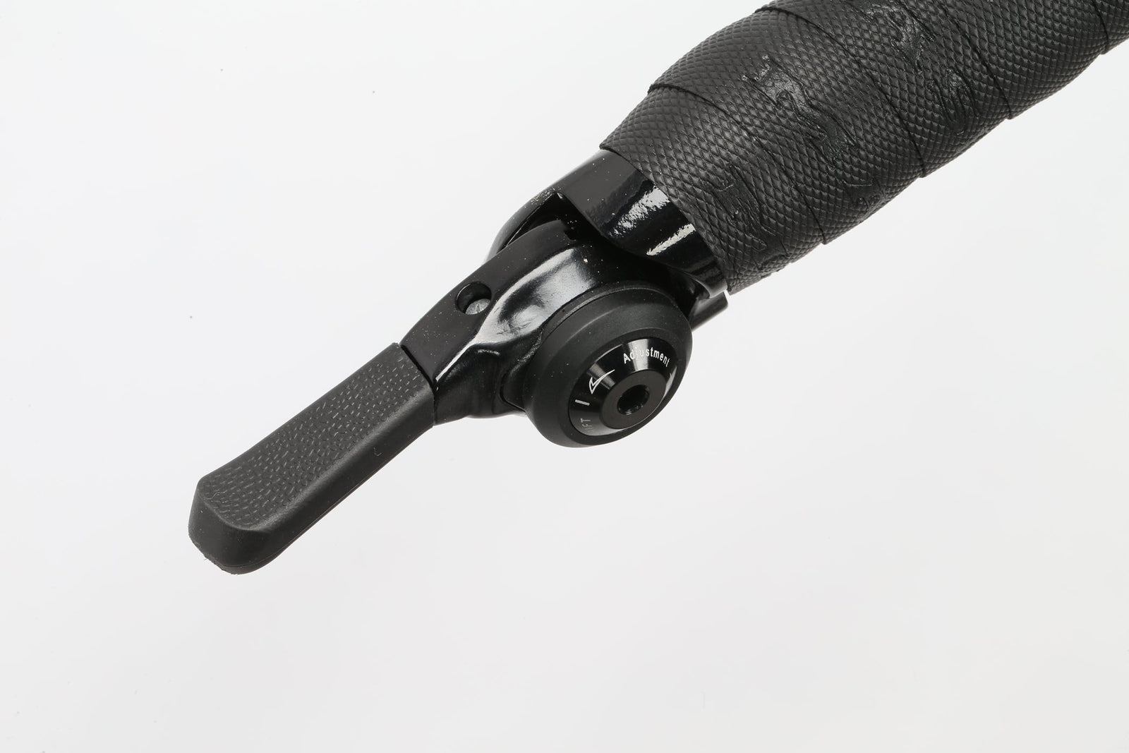 Close-up of a Masi Bikes GIRAMONDO 700c gear shifter with a textured handlebar grip, isolated on white, ideal for your next adventure or touring bike journey.